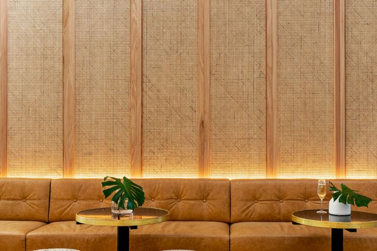 a living room filled with lots of furniture and plants on top of wooden stools