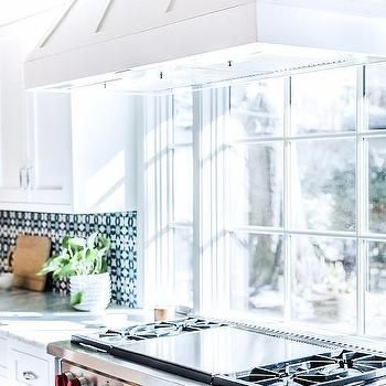 a stove top oven sitting inside of a kitchen