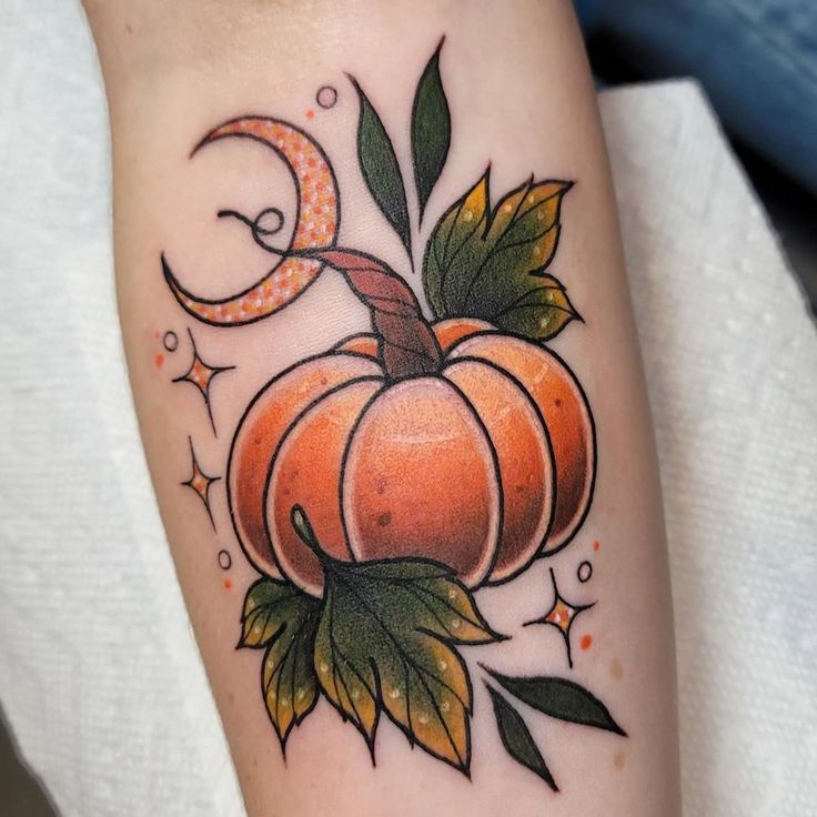 a tattoo with a pumpkin and moon on it