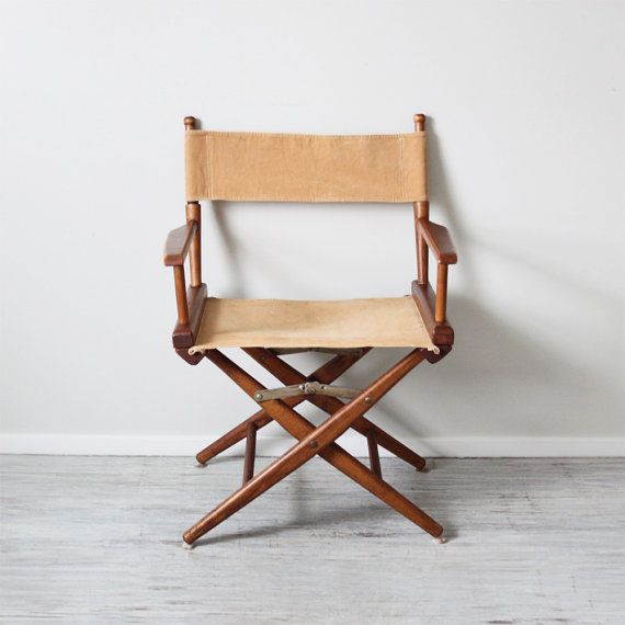 a wooden folding chair against a white wall