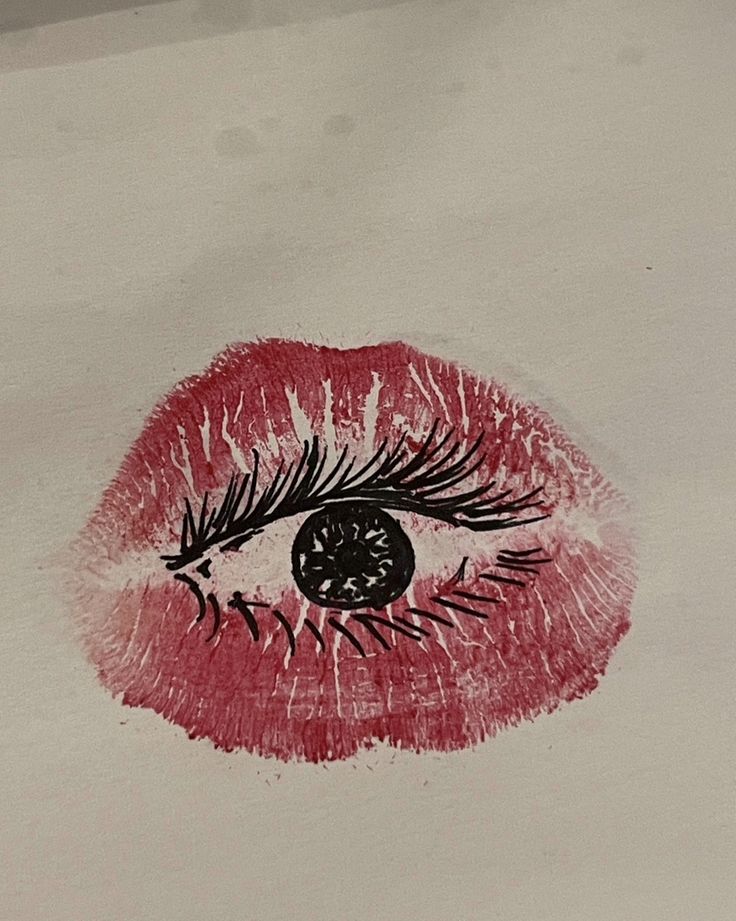 a drawing of a woman's eye with red lipstick and eyelashes on white paper