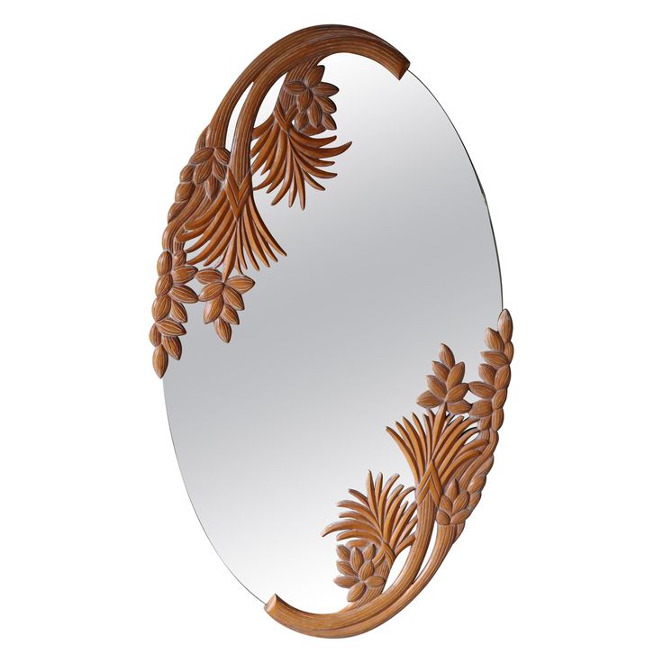 an oval mirror with wooden carvings on it