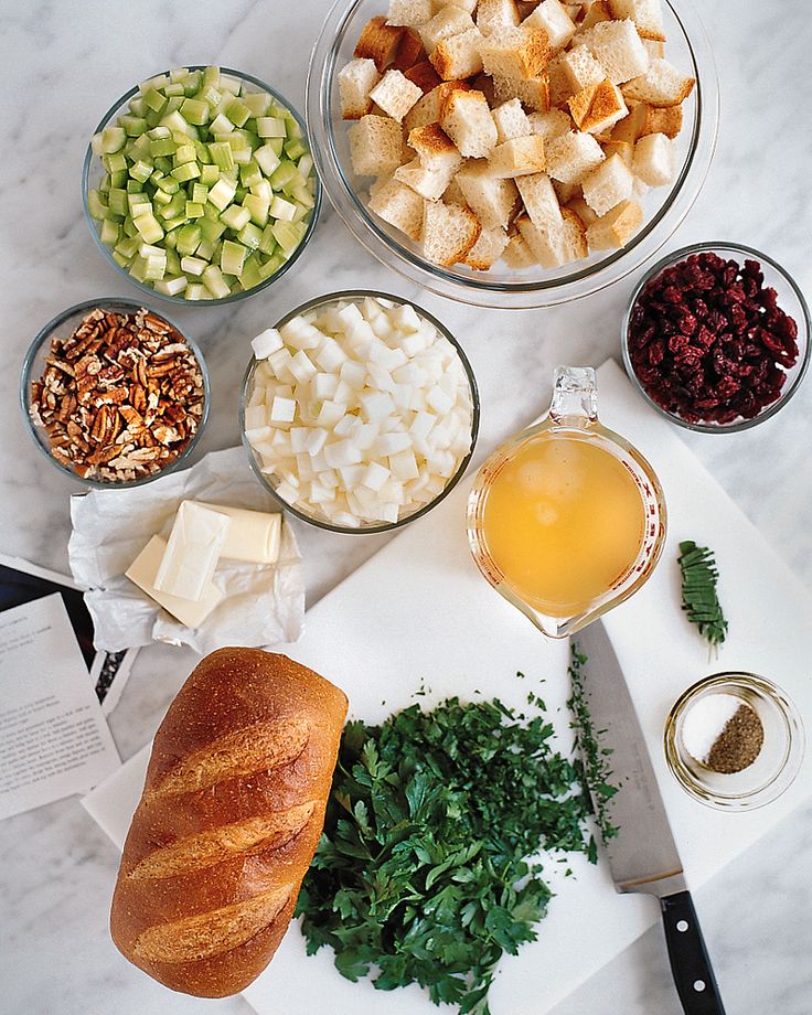 an assortment of food is laid out on a cutting board and ready to be cooked