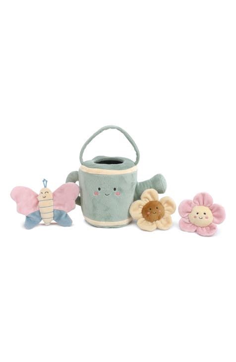 three stuffed animals are sitting next to a toy bucket and flower pot on a white background