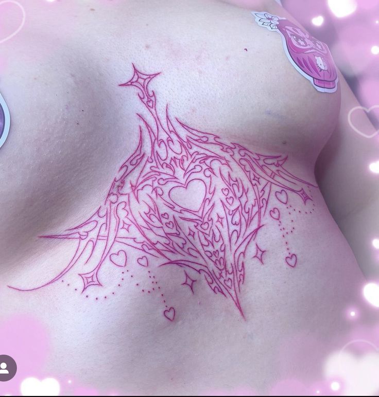 a woman's breast with tattoos on it and hearts around the breast, in pink