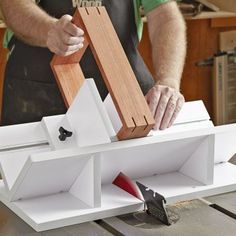 a man is working on a piece of wood with a plane in the middle of it