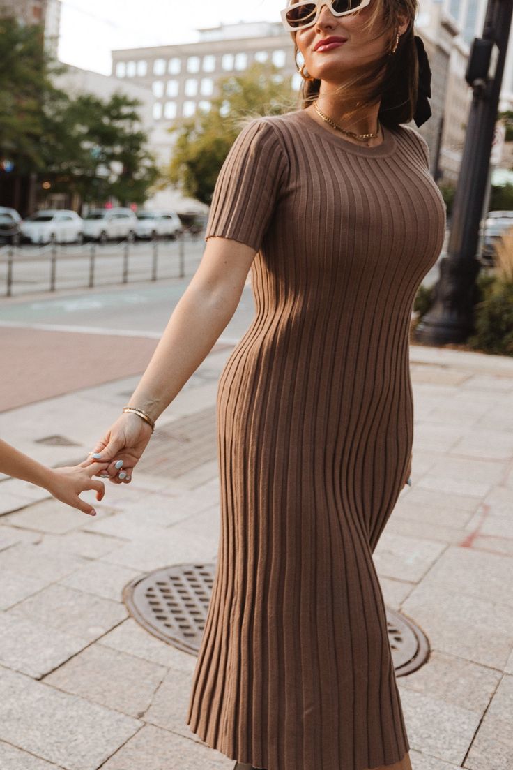 The perfect addition to your fall wardrobe is here - the Alexa Dress in Taupe! Made from a soft and comfortable taupe knit fabric, this modest women's dress features a round neckline and short fitted sleeves. The midi-length skirt and pull-over style make it both stylish and easy to wear. Plus, it's maternity friendly! Modest Short Sleeve Dresses For Fall, Ribbed Stretch Midi Dress With Short Sleeves, Brown Short Sleeve Midi Dress For Fall, Modest Short Sleeve Midi Dress For Fall, Casual Knit Short Sleeve Midi Dress, Fall Midi Dress With Short Sleeves, Modest Beige Knee-length Midi Dress, Modest Stretch Midi Dress For Fall, Modest Brown Midi Dress