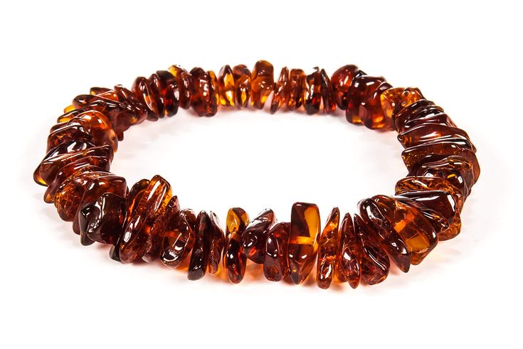 a bracelet made out of brown glass beads on a white background with clippings