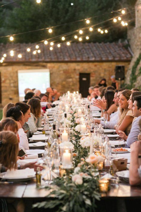 a group of people sitting around a long table