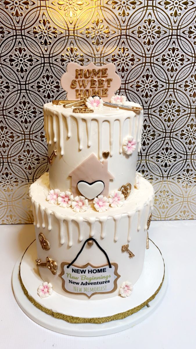 a three tiered cake with white icing and pink flowers