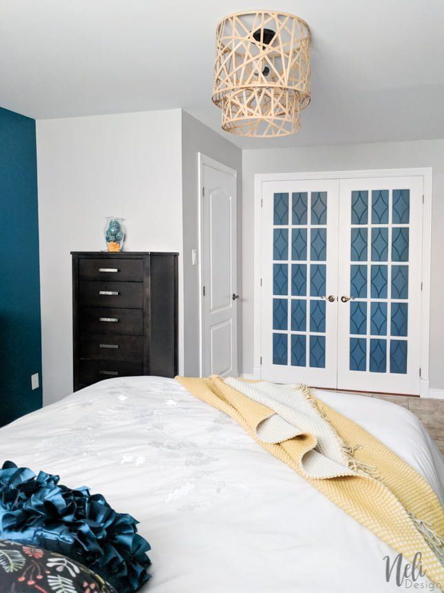 a bedroom with blue walls and white bedding