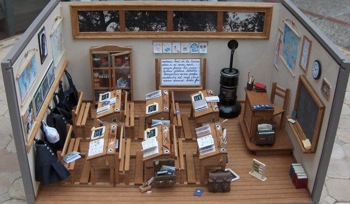 a doll house with furniture and pictures on the walls, including chairs and desks