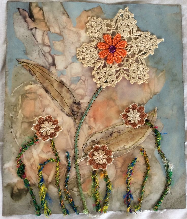 an art piece with flowers and beads on it