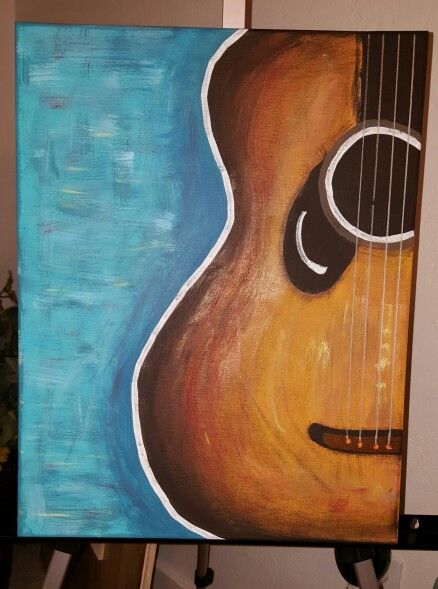 a painting of an acoustic guitar is hanging on the wall