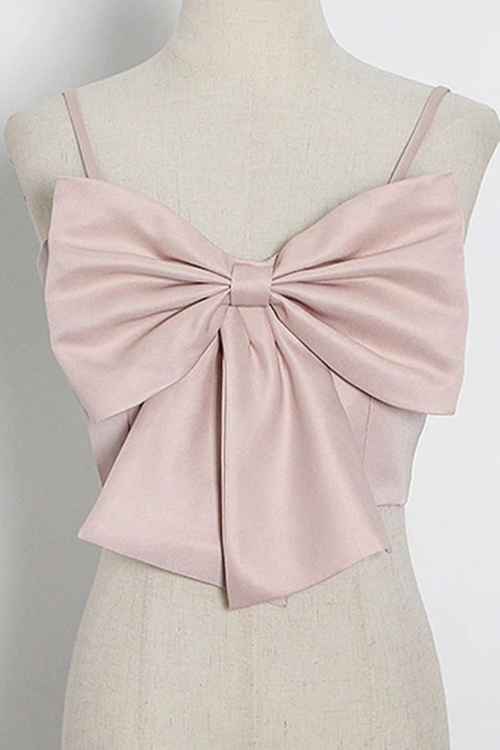 Bow front spaghetti strap tank top with button back closure.True to sizecotton/poly blend Cheap Elegant Pink Crop Top, Cheap White Tops For Graduation Party, Luxury Feminine Crop Top For Spring, Luxury Bow Top For Daywear, Luxury Cropped Blouse For Summer, Luxury Sleeveless Top With Bow, Cheap Summer Tops With Bow, Chic Cheap Pink Tops, Cheap Tops For College Graduation