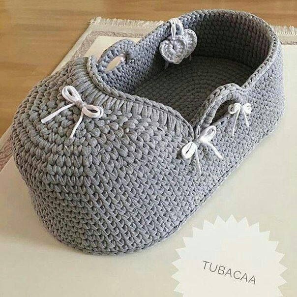 a gray crocheted basket sitting on top of a table