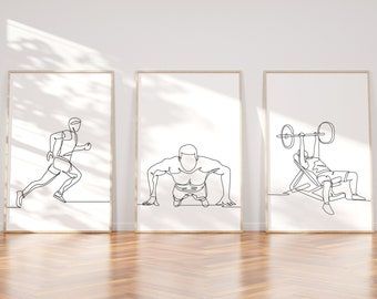 three framed art prints on a wooden floor in front of a white wall with an image of a man doing squats