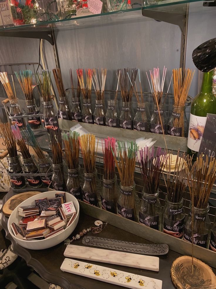 an assortment of candles and incense sticks on display