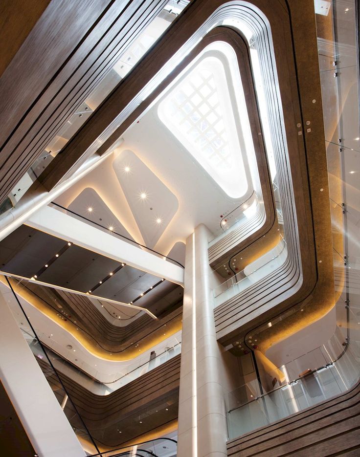 the inside of a building with many stairs and lights on it's ceiling area