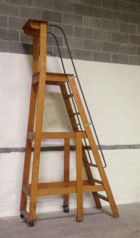 a wooden step ladder leaning against a wall