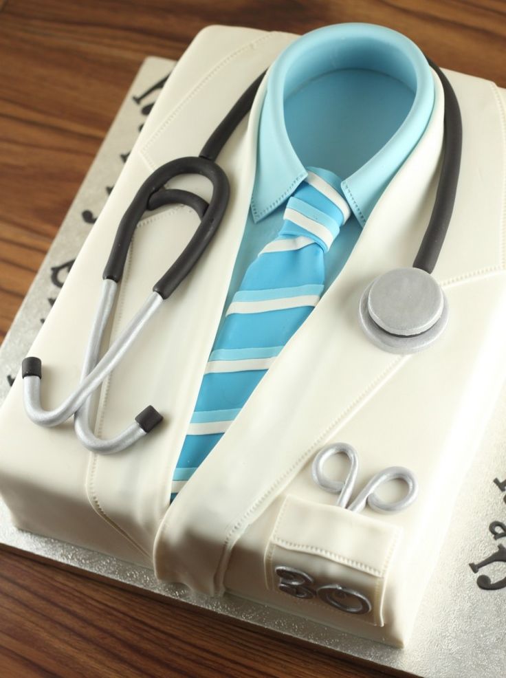 a cake with a doctor's tie and stethoscope on it