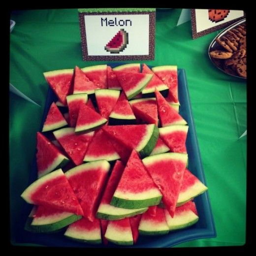 watermelon slices are arranged on a blue platter next to crackers and cookies