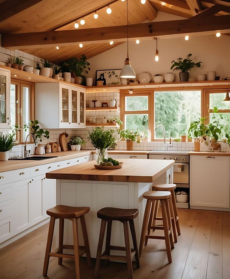 a kitchen filled with lots of counter top space and wooden stools next to an island