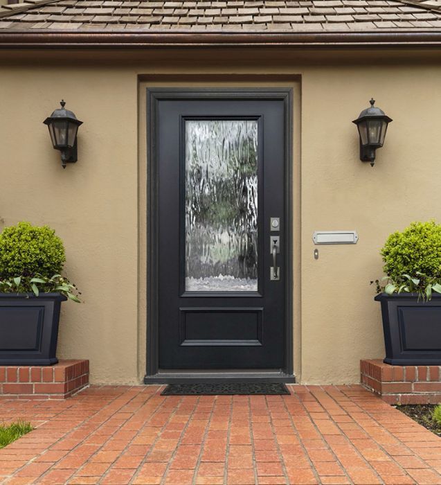 a black front door with two planters on either side