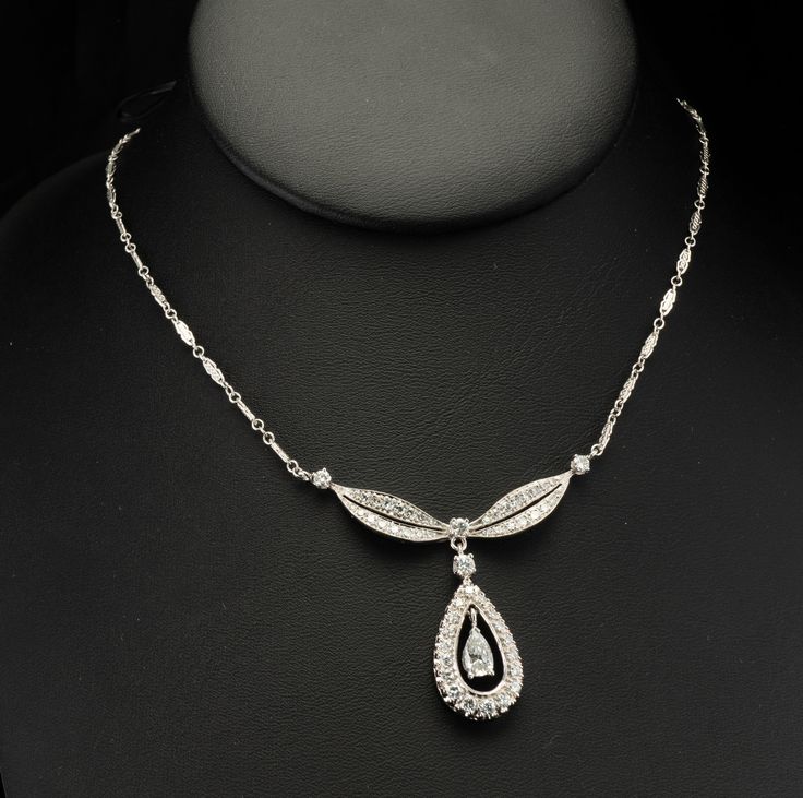 "Art Deco Necklace, Genuine Diamond Necklace, Vintage Necklace, 14K White Gold Necklace, Gold Chain, Diamond Pendant, Teardrop Pendant, April Birthstone, 1930s Necklace. This beautiful vintage Necklace & Pendant is finely crafted in solid 14K White Gold and set with white and fiery diamonds. The center pear cut diamond is .60 carat of SI2 clarity and G color. It is surrounded by 18 single cut diamonds of VS1 clarity and G color = .72 carat. Four round brilliant cut diamonds are SI1 clarity a Classic Formal Drop Necklace With Diamond Cut, Classic Formal Drop Necklace With Diamond Accents, Elegant Oval Drop Necklace For Formal Occasions, Formal Teardrop Diamond Necklace With 17 Jewels, Teardrop Diamond Necklace With 17 Jewels For Formal Occasions, Art Deco Oval Diamond Necklaces, Art Deco White Gold Necklace With Rose Cut Diamonds, Formal Teardrop Pendant Drop Necklace With 17 Jewels, Art Deco Oval Diamond Necklace