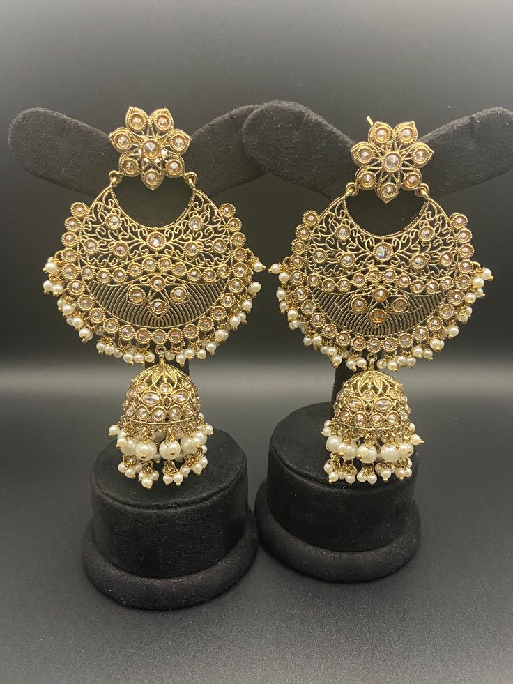 MK  Chandbali antique earrings are an instant charmer. The meticulously-crafted design of these earrings has a striking look. Wear this pair to add a degree of visual intrigue to your ensemble.  Want to elevate your look with a dose of drama? MK Chandbali antique earrings are the right pick. The thought-out combination of high-quality and bright-colored CZ stones gives this pair of earrings an irresistible charm.   Specifications: Earrings Length: 12 cm 100% Satisfaction Guarantee: 1 Year Warranty, Long Lasting Plating, High-Quality Stones. Gifting: This pair of charming earrings come in a beautiful packaging making it an ideal gift for birthday, wedding anniversary or wedding gift.  Occasion: Perfect choice for any Indian occasion.  Care: It is advisable that you keep MK products away fro Traditional Oxidized Hoop Earrings For Festive Occasions, Gold Oxidized Finish Jhumkas For Festivals, Festive Gold Oxidized Jhumkas, Traditional Gold Metal Chandbalis, Festive Brass Jhumkas, Festive Brass Bridal Drop Earrings, Elegant Metal Chandbali Earrings, Antique Gold Earrings With Intricate Design For Festive Occasions, Gold Metal Chandbalis With Intricate Design