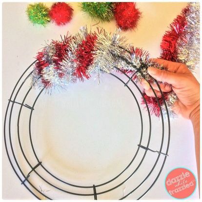 someone is making a christmas wreath out of tinsel and pom - poms