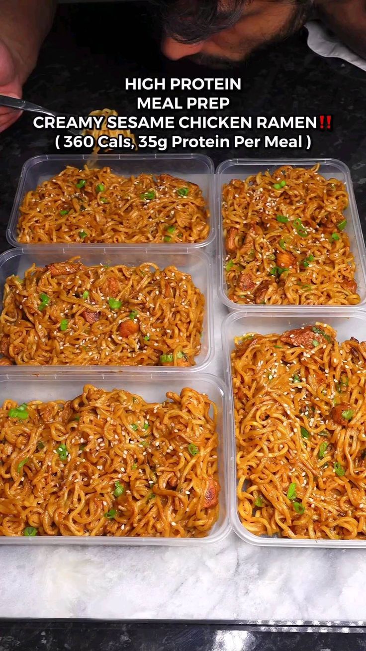 four plastic trays filled with noodles on top of a marble countertop next to a man