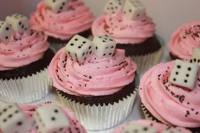 cupcakes decorated with dice and pink frosting