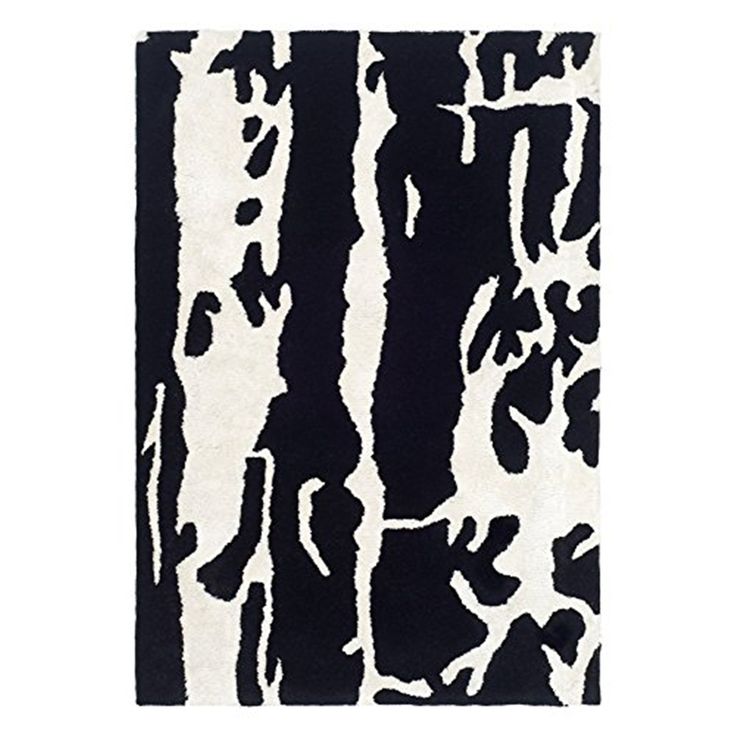 a black and white rug with an abstract design on the bottom, in front of a white background