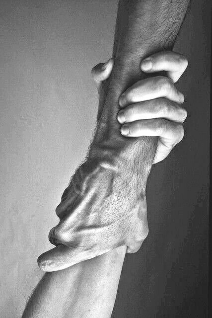 two hands holding each other in black and white