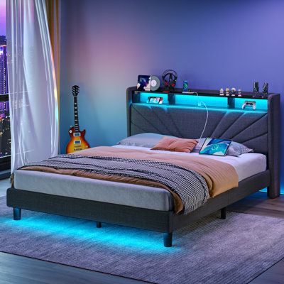 a bed with a guitar on the headboard and blue lights in the night time