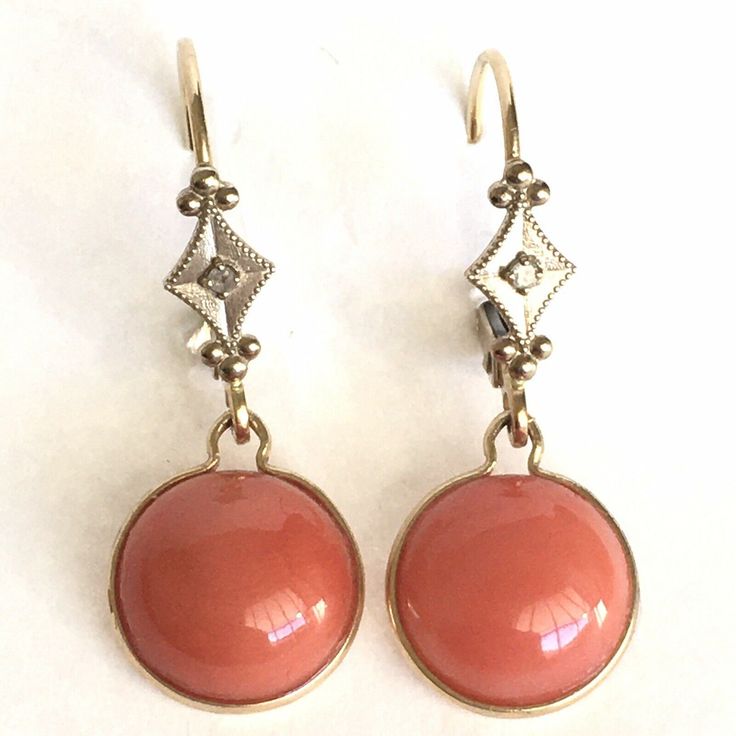 Vintage 14K Yellow & White Gold Natural Coral & Diamond Earrings  Hanging One Inch  circa 1980s Antique Workmanship American made Shipped Insured First Class USPS  ** No international sales for Coral jewelry !4 Karat gold and Natural Coral earrings circa 1980s, weighting 1.5 gram, 9.5mm half round Coral Cabochon, hanging One Inch form ear, detailed work in excellent condition considering its age Heirloom Style Earrings For Formal Occasions, Vintage Yellow Gold Dangle Earrings, Vintage Yellow Gold Evening Earrings, Vintage Yellow Gold Earrings For Evening, Heirloom Earrings For Formal Occasions, Vintage Yellow Gold Earrings For Anniversary, Vintage Sterling Silver Earrings With 17 Jewels, Vintage 14k Gold Evening Earrings, Vintage Yellow Gold Jewelry With Matching Earrings