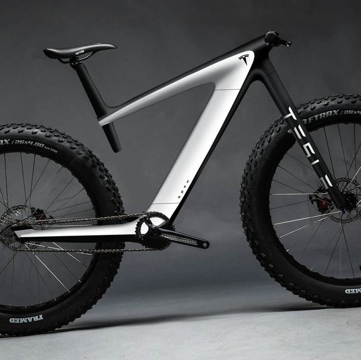 the front end of a mountain bike against a gray background with black and white details