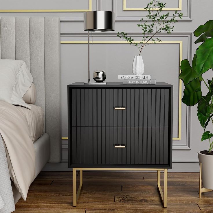 a bedroom with a bed, nightstand and potted plant on the side table next to it