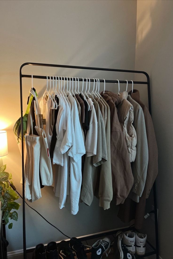 an iron rack with clothes hanging on it