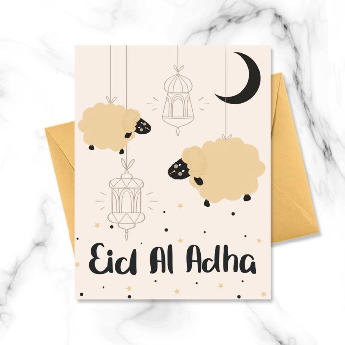 a card with two sheep hanging from strings and the words, eid al aha