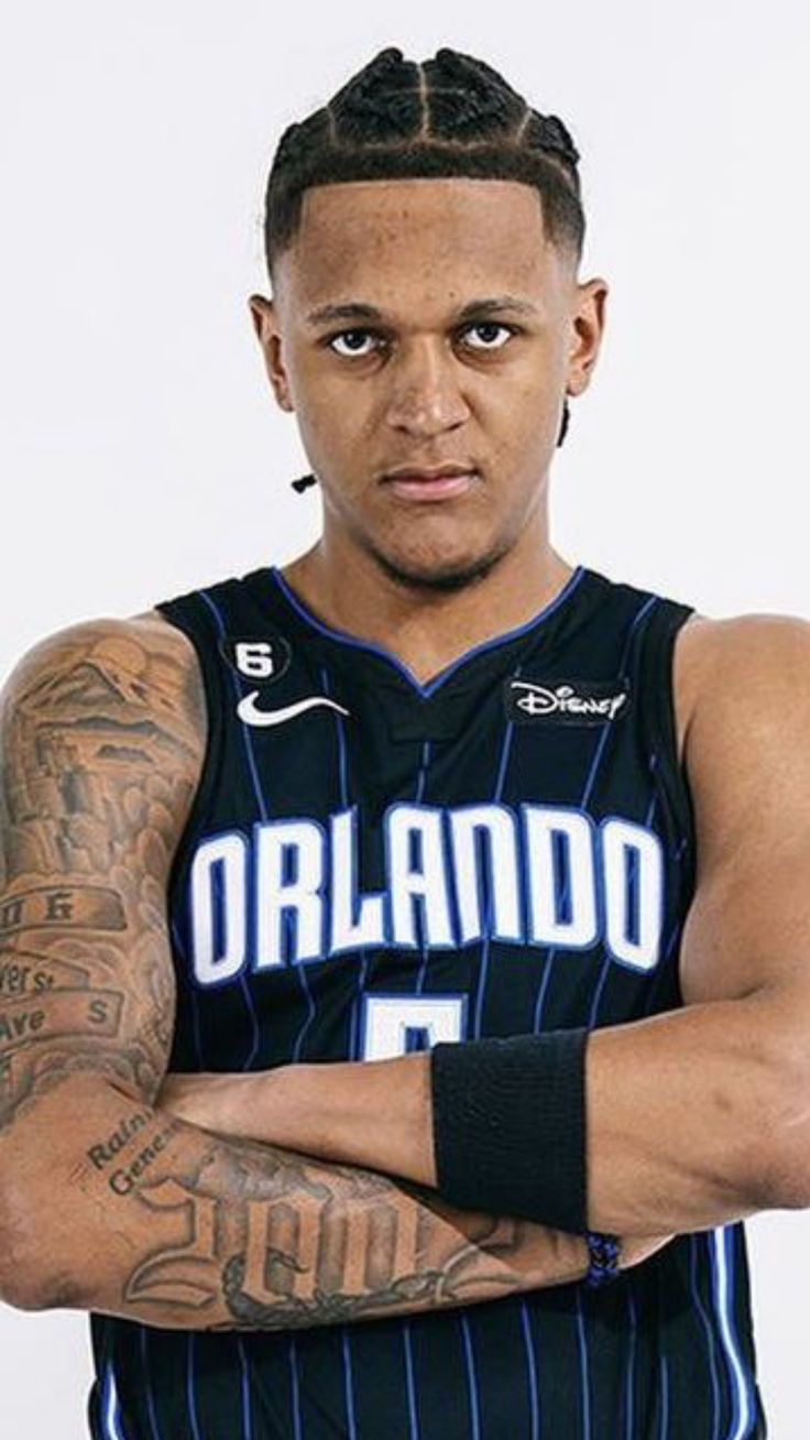 a basketball player with his arms crossed