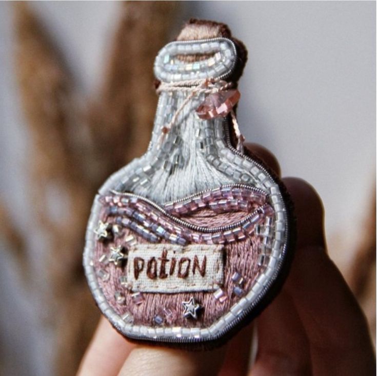 a hand holding a small bottle with the word potton on it's side