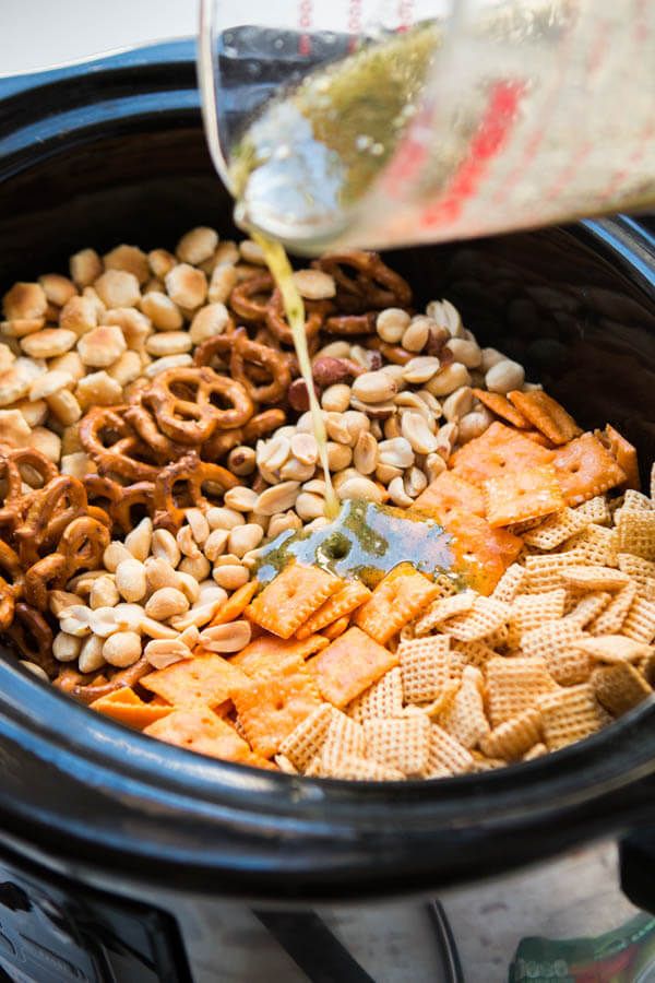 a crock pot filled with cheetos and cereal