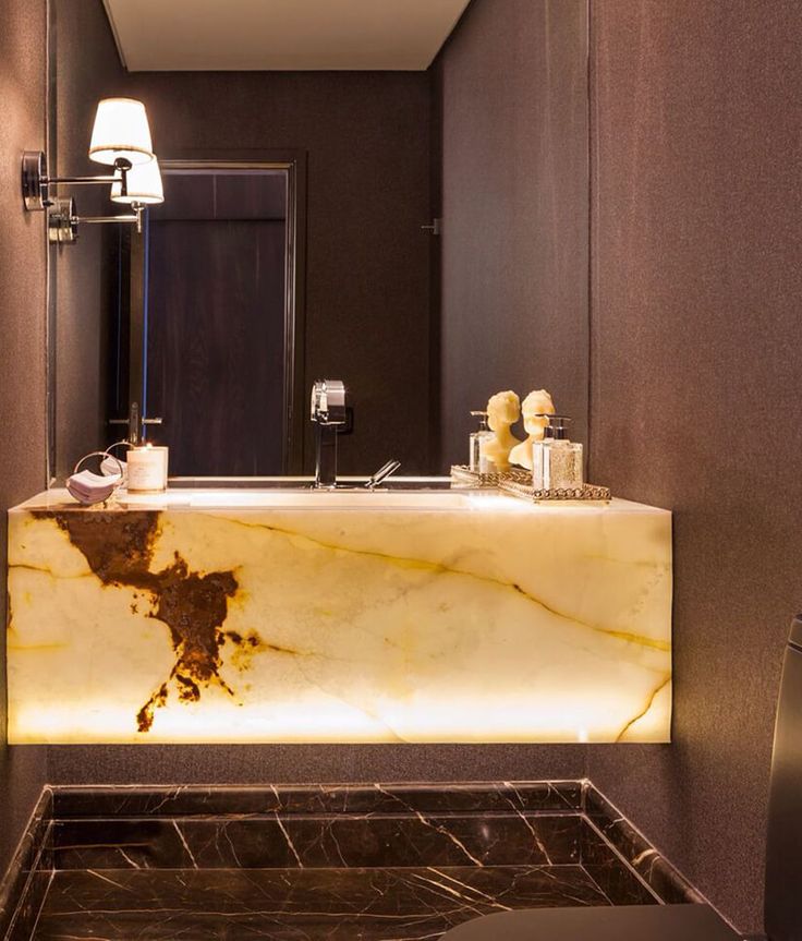 a bathroom with a marble sink and mirror