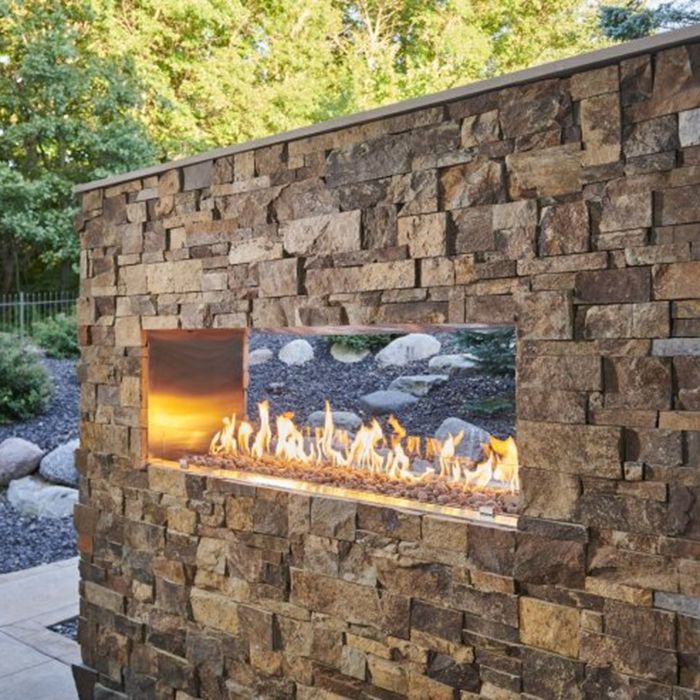 an outdoor fireplace with rocks surrounding it