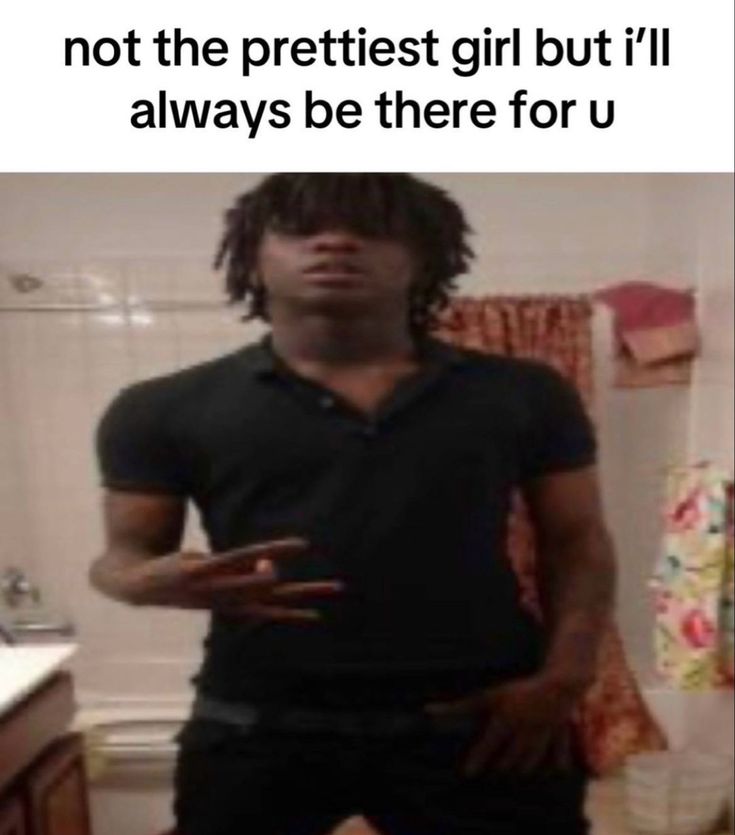 a man with dreadlocks standing in front of a bathroom sink and looking at the camera