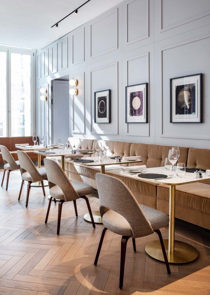 an empty restaurant with long tables and chairs