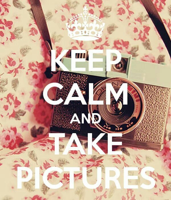 a camera sitting on top of a bed with the words keep calm and take pictures