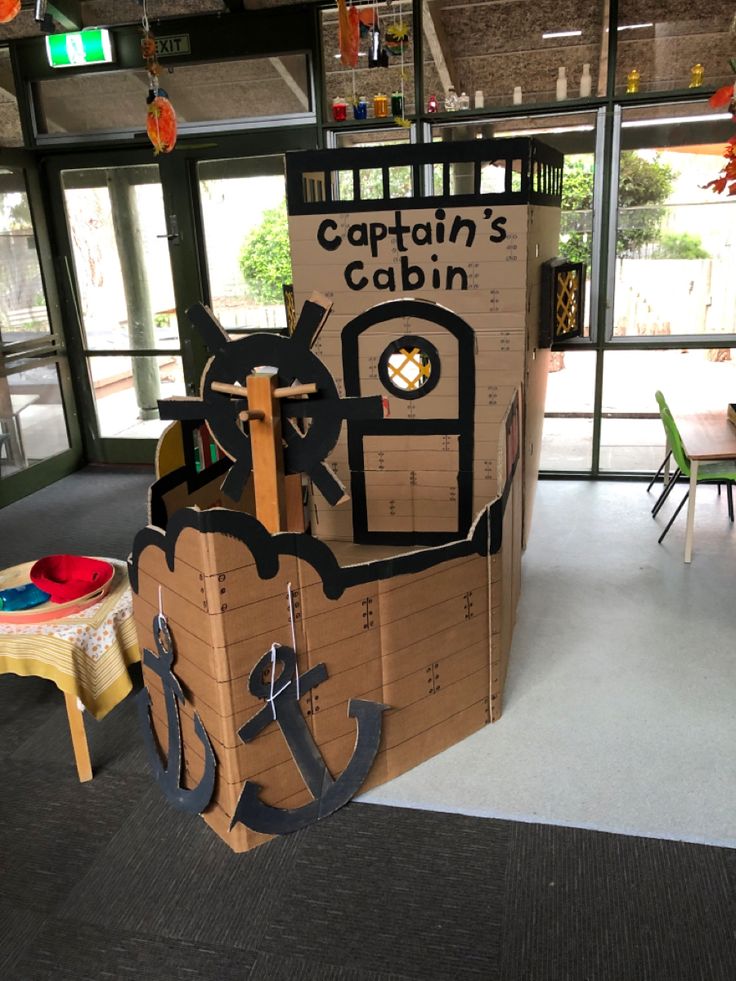 a cardboard boat made to look like a captain's cabin with an anchor on it